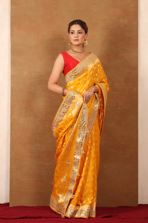 Buy yellow georgette Banarasi saree online in USA with embroidered border. Make a fashion statement at weddings with stunning designer sarees, embroidered sarees with blouse, wedding sarees, handloom sarees from Pure Elegance Indian fashion store in USA.-front