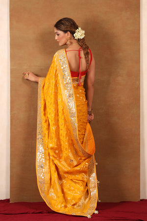 Buy yellow georgette Banarasi saree online in USA with embroidered border. Make a fashion statement at weddings with stunning designer sarees, embroidered sarees with blouse, wedding sarees, handloom sarees from Pure Elegance Indian fashion store in USA.-back
