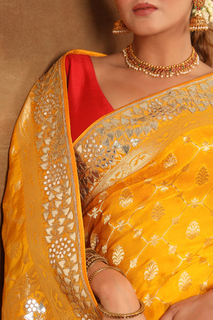 Buy yellow georgette Banarasi saree online in USA with embroidered border. Make a fashion statement at weddings with stunning designer sarees, embroidered sarees with blouse, wedding sarees, handloom sarees from Pure Elegance Indian fashion store in USA.-details