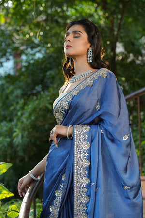 Shop blue tussar georgette saree online in USA with embroidered border. Make a fashion statement at weddings with stunning designer sarees, embroidered sarees with blouse, wedding sarees, handloom sarees from Pure Elegance Indian fashion store in USA.-closeup