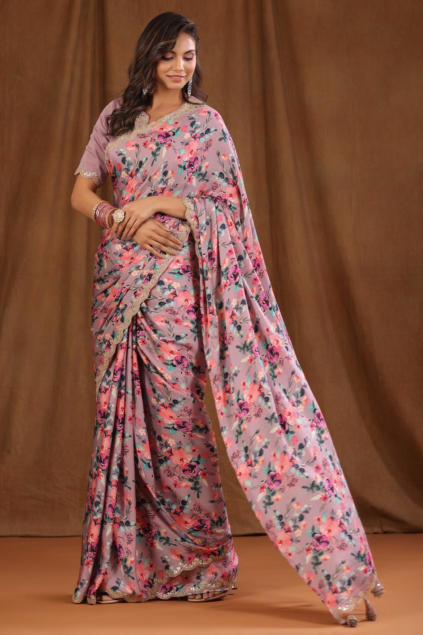 Buy beautiful onion pink floral crepe sari online in USA with scalloped border. Make a fashion statement at weddings with stunning designer sarees, embroidered sarees with blouse, wedding sarees, handloom sarees from Pure Elegance Indian fashion store in USA.-pallu