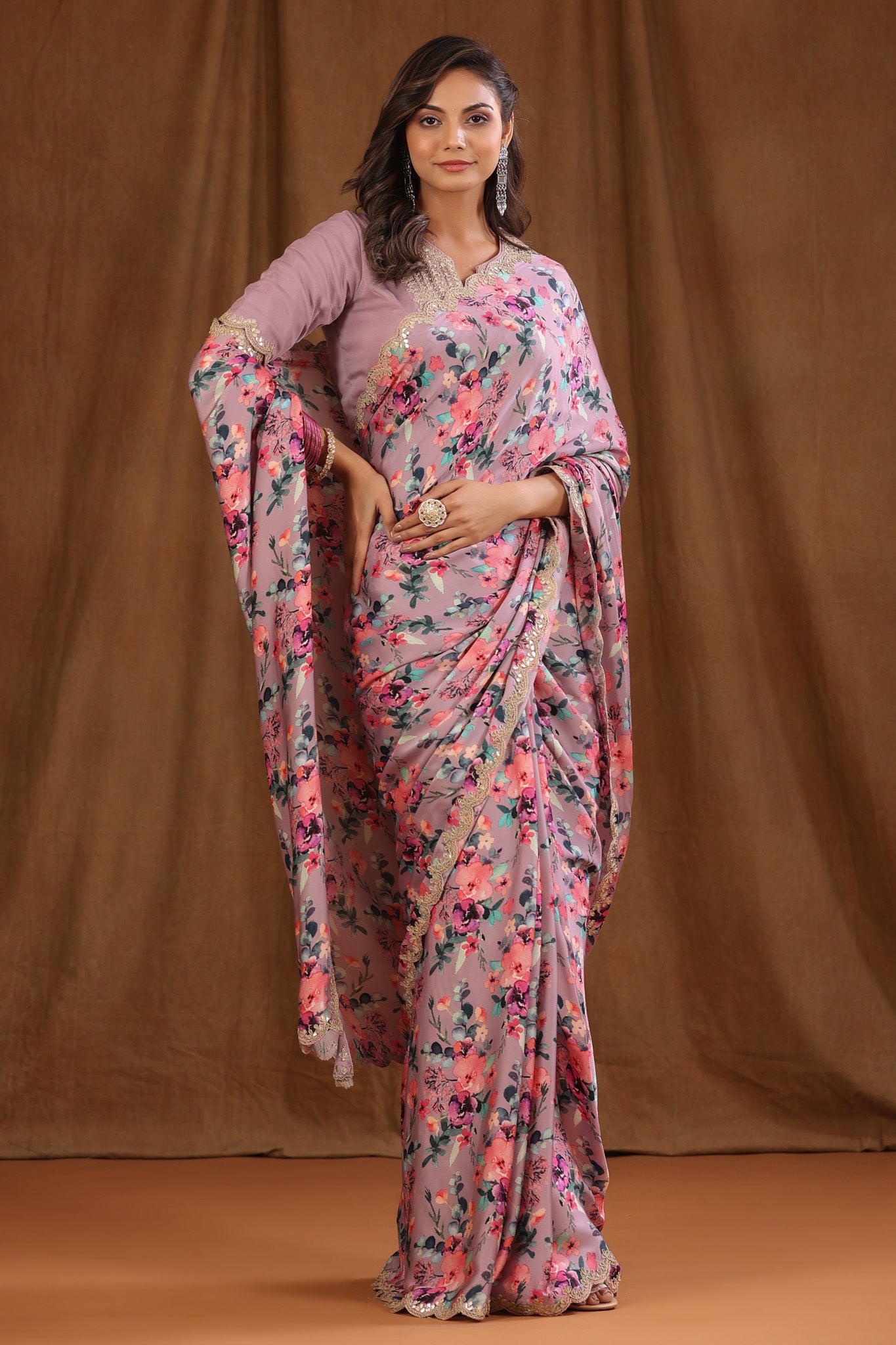 Buy beautiful onion pink floral crepe sari online in USA with scalloped border. Make a fashion statement at weddings with stunning designer sarees, embroidered sarees with blouse, wedding sarees, handloom sarees from Pure Elegance Indian fashion store in USA.-full view
