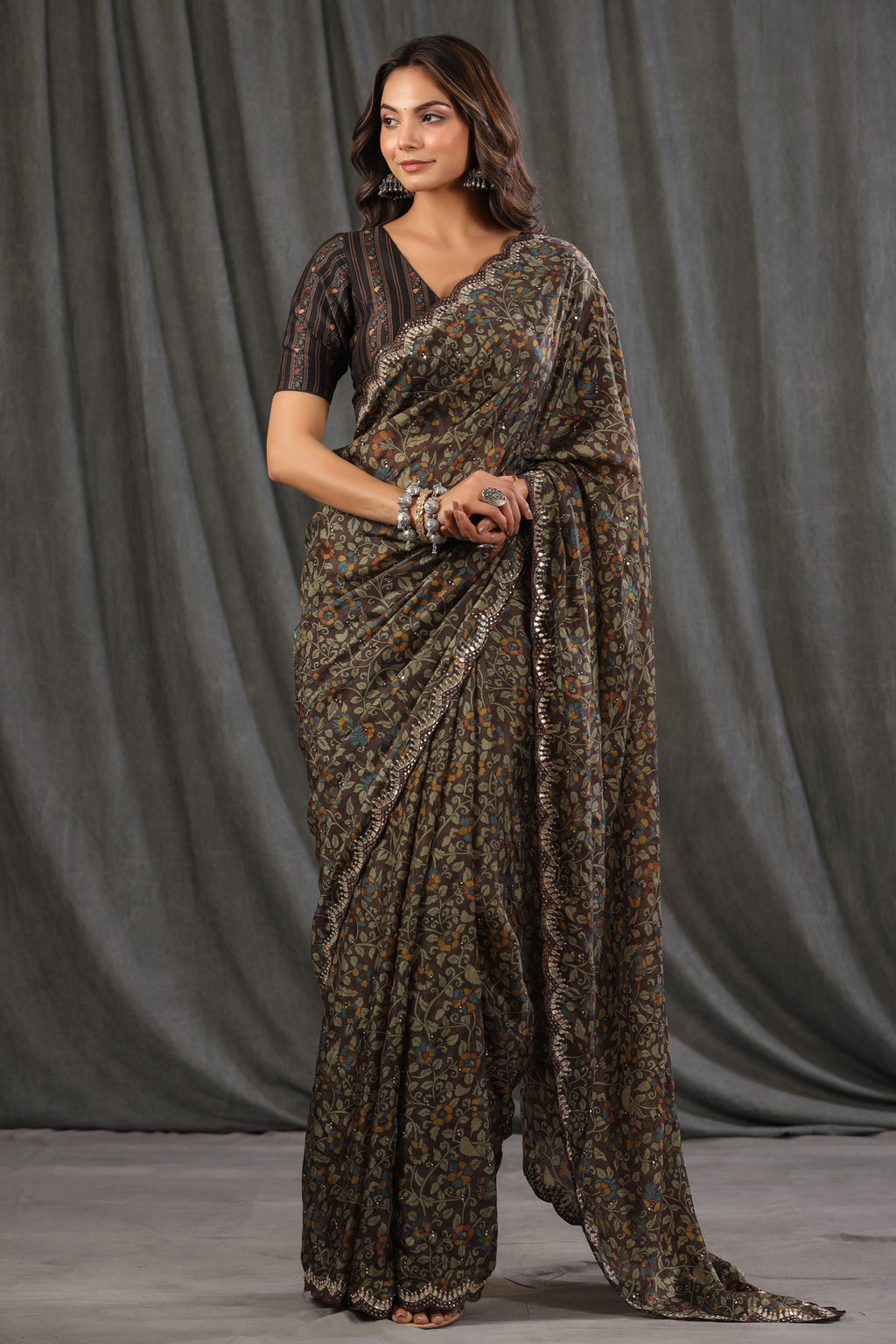 Shop dark brown floral crepe saree online in USA with scalloped border. Make a fashion statement at weddings with stunning designer sarees, embroidered sarees with blouse, wedding sarees, handloom sarees from Pure Elegance Indian fashion store in USA.-full view