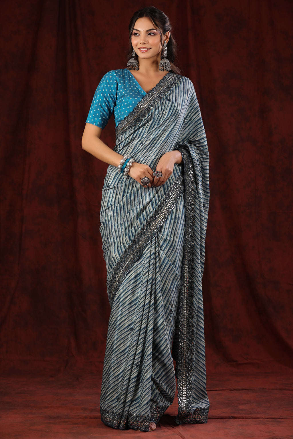 Shop blue stripes crepe saree online in USA with scalloped border. Make a fashion statement at weddings with stunning designer sarees, embroidered sarees with blouse, wedding sarees, handloom sarees from Pure Elegance Indian fashion store in USA.-full view