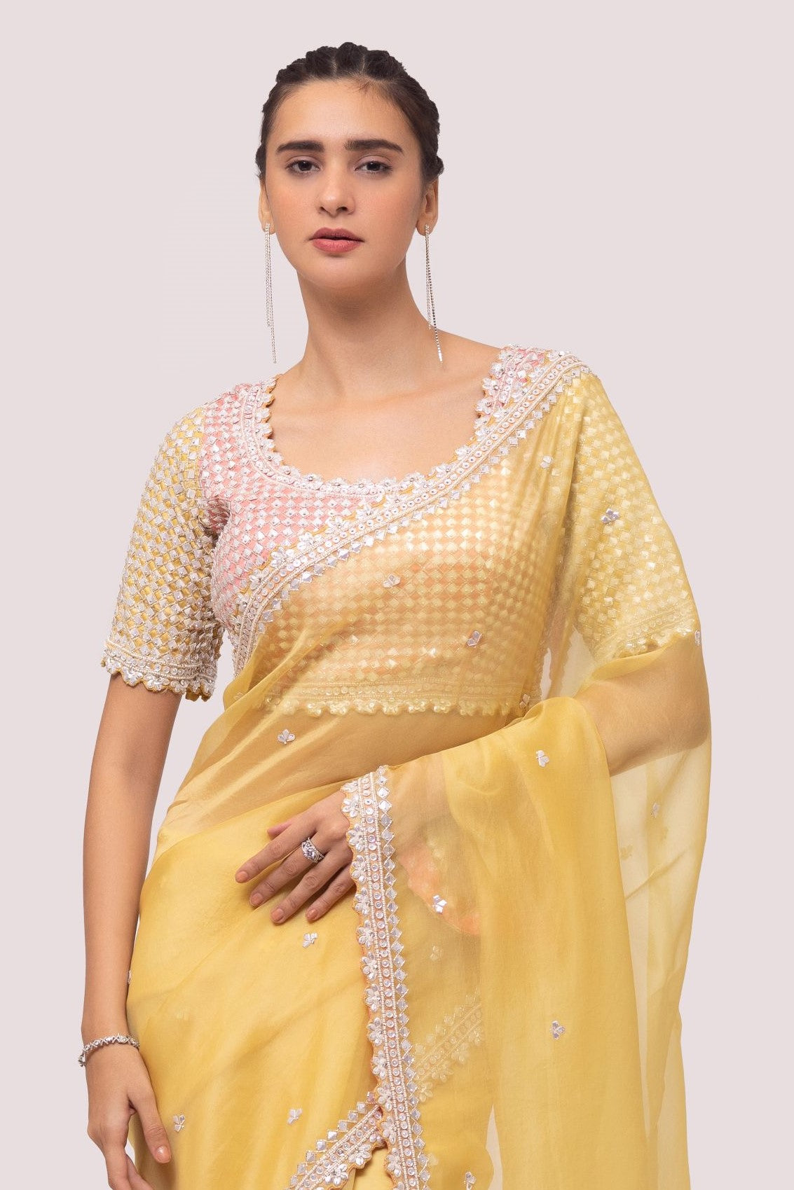 Shop yellow georgette saree with decorative edges featuring sequin work, and sequin embroidered blouse detailing is a perfect choice for parties! It comes with a designer saree blouse. Make a fashion statement at weddings with stunning designer sarees, embroidered sarees with blouses, wedding sarees, and handloom sarees from Pure Elegance Indian fashion store in the USA.