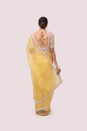 Shop yellow georgette saree with decorative edges featuring sequin work, and sequin embroidered blouse detailing is a perfect choice for parties! It comes with a designer saree blouse. Make a fashion statement at weddings with stunning designer sarees, embroidered sarees with blouses, wedding sarees, and handloom sarees from Pure Elegance Indian fashion store in the USA.