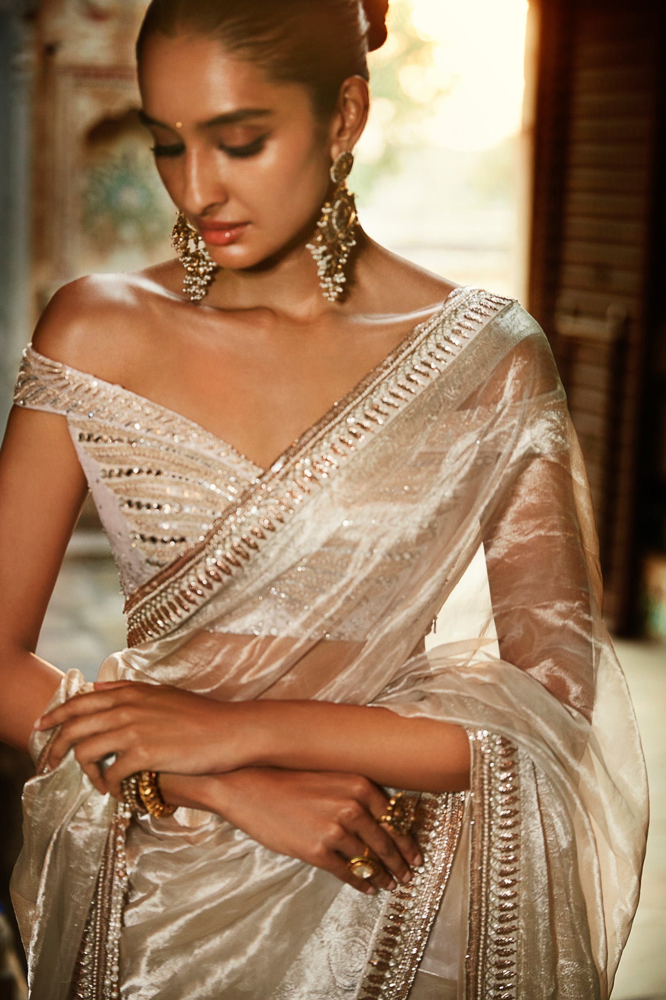 Shop a silver wrinkled saree online in USA with a saree blouse. Make a fashion statement on festive occasions and weddings with designer sarees, designer suits, Indian dresses, Anarkali suits, palazzo suits, designer gowns, sharara suits, and embroidered sarees from Pure Elegance Indian fashion store in USA.