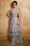 Shop this beautiful grey ruffled organza saree with pearl embroidered work on the blouse. It can make you look more elegant. Shop designer saris online in USA from Pure Elegance. Make a fashion statement on festive occasions and weddings with designer sarees, designer suits, Indian dresses, Anarkali suits, palazzo suits, designer gowns, sharara suits, and embroidered sarees from Pure Elegance Indian fashion store in USA.- Front View