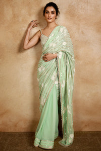Buy a beautiful mint green embroidered georgette saree with floral print embroidery. It comes with a designer saree blouse with pearl embellishment. Make a fashion statement on festive occasions and weddings with designer sarees, designer suits, Indian dresses, Anarkali suits, palazzo suits, designer gowns, sharara suits, and embroidered sarees from Pure Elegance Indian fashion store in USA.