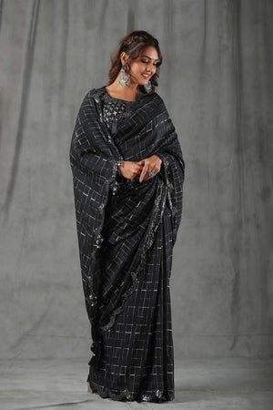 Buy black printed crepe saree online in USA with scalloped border. Make a fashion statement at weddings with stunning designer sarees, embroidered sarees with blouse, wedding sarees, handloom sarees from Pure Elegance Indian fashion store in USA.-front