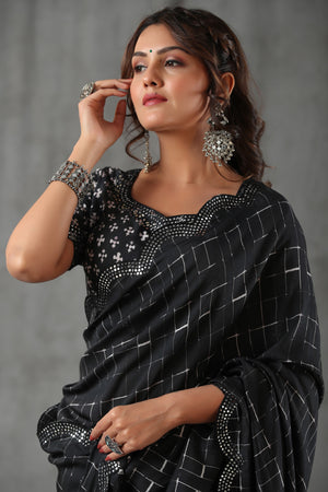Buy black printed crepe saree online in USA with scalloped border. Make a fashion statement at weddings with stunning designer sarees, embroidered sarees with blouse, wedding sarees, handloom sarees from Pure Elegance Indian fashion store in USA.-closeup