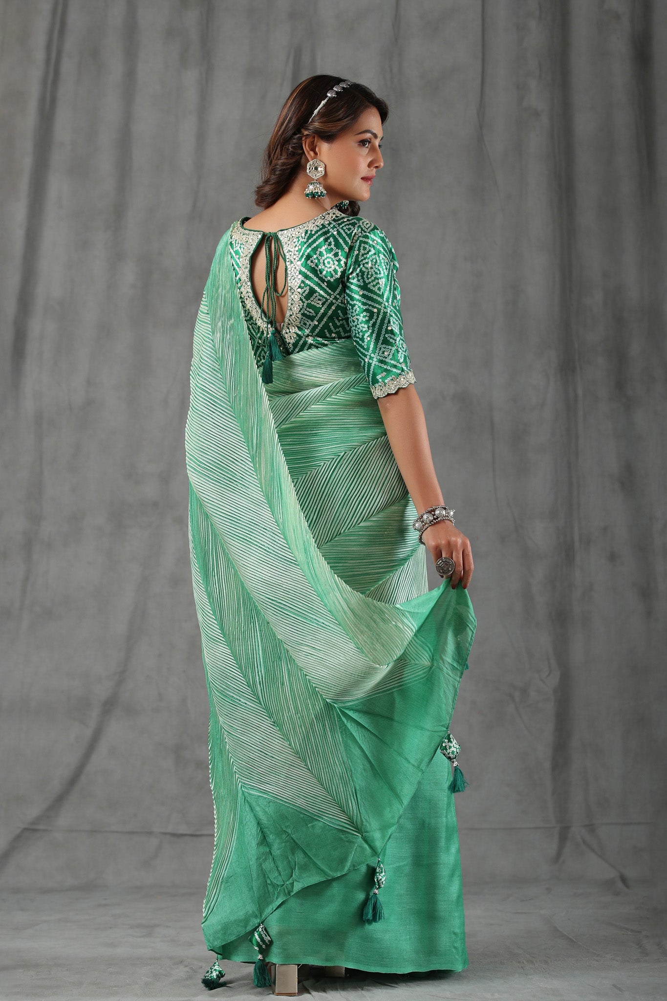 Shop pastel green stripes tussar silk saree online in USA with bandhej saree blouse. Make a fashion statement at weddings with stunning designer sarees, embroidered sarees with blouse, wedding sarees, handloom sarees from Pure Elegance Indian fashion store in USA.-back
