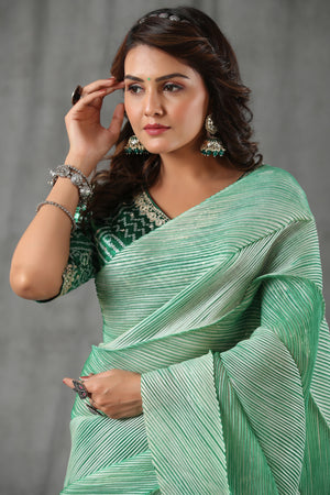 Shop pastel green stripes tussar silk saree online in USA with bandhej saree blouse. Make a fashion statement at weddings with stunning designer sarees, embroidered sarees with blouse, wedding sarees, handloom sarees from Pure Elegance Indian fashion store in USA.-closeup