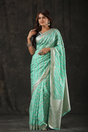 Shop mint green georgette Banarasi saree online in USA with zari stripes. Make a fashion statement at weddings with stunning designer sarees, embroidered sarees with blouse, wedding sarees, handloom sarees from Pure Elegance Indian fashion store in USA.-front
