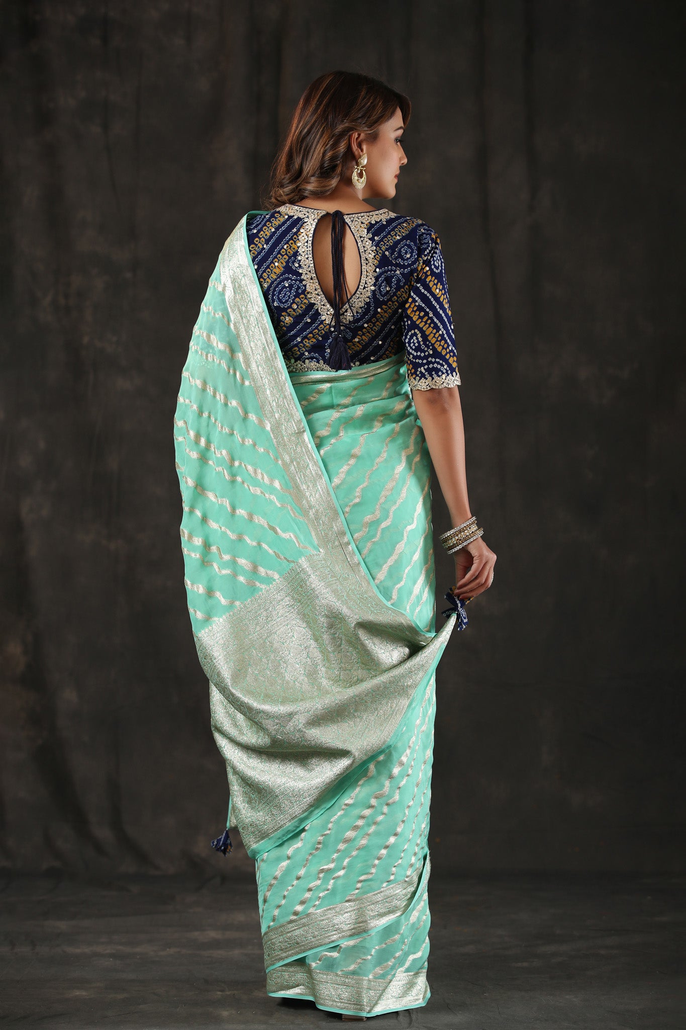 Shop mint green georgette Banarasi saree online in USA with zari stripes. Make a fashion statement at weddings with stunning designer sarees, embroidered sarees with blouse, wedding sarees, handloom sarees from Pure Elegance Indian fashion store in USA.-back