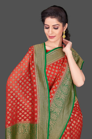 Buy beautiful red georgette Banarasi saree online in USA with green antique zari border. Shop beautiful Banarasi sarees, georgette sarees, pure muga silk sarees in USA from Pure Elegance Indian fashion boutique in USA. Get spoiled for choices with a splendid variety of Indian saris to choose from! Shop now.-closeup