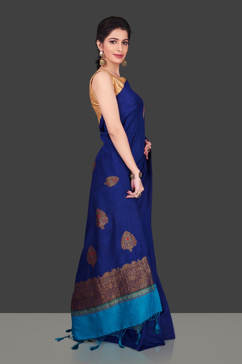 Buy stunning dark blue borderless muga Banarasi sari online in USA with floral zari buta. Shop beautiful Banarasi sarees, georgette sarees, pure muga silk sarees in USA from Pure Elegance Indian fashion boutique in USA. Get spoiled for choices with a splendid variety of designer saris to choose from! Shop now.-side