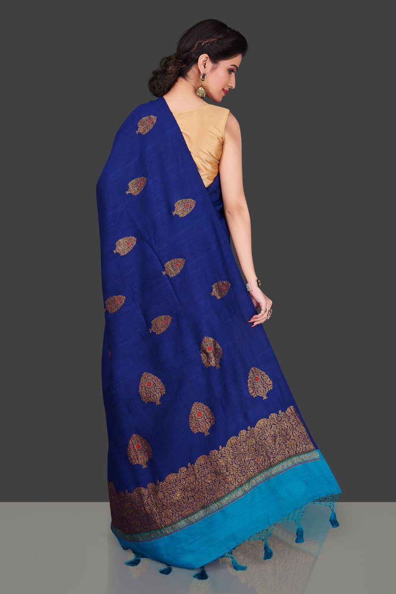Buy stunning dark blue borderless muga Banarasi sari online in USA with floral zari buta. Shop beautiful Banarasi sarees, georgette sarees, pure muga silk sarees in USA from Pure Elegance Indian fashion boutique in USA. Get spoiled for choices with a splendid variety of designer saris to choose from! Shop now.-back