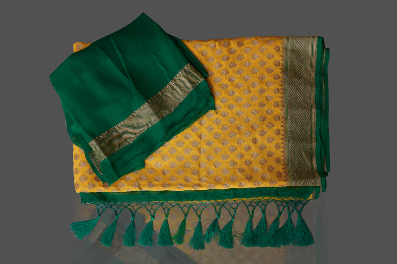 Shop lovely yellow georgette Banarasi saree online in USA with green zari border. Shop beautiful Banarasi georgette sarees, tussar sarees, pure muga silk sarees in USA from Pure Elegance Indian fashion boutique in USA. Get spoiled for choices with a splendid variety of Indian saris to choose from! Shop now.-details