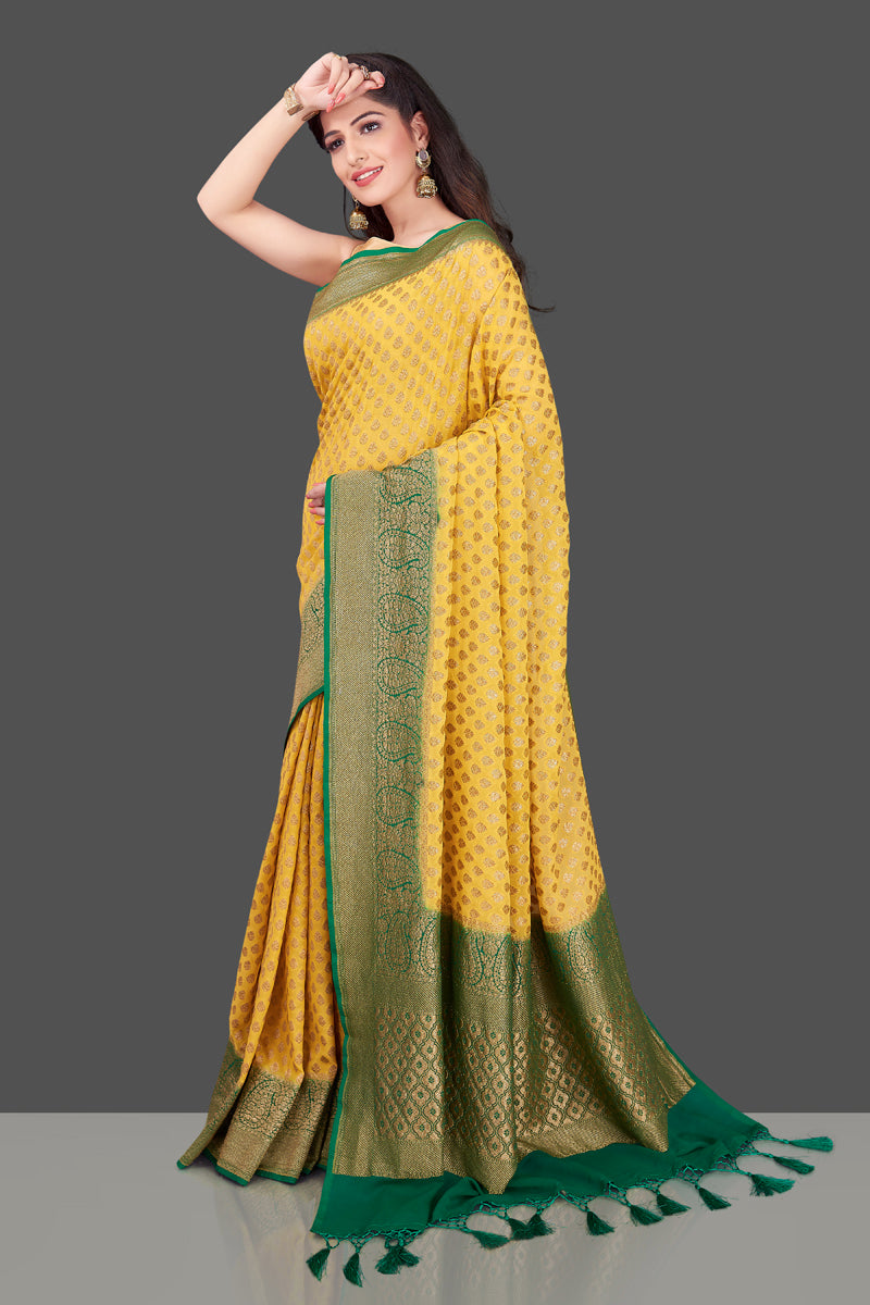 Shop lovely yellow georgette Banarasi saree online in USA with green zari border. Shop beautiful Banarasi georgette sarees, tussar sarees, pure muga silk sarees in USA from Pure Elegance Indian fashion boutique in USA. Get spoiled for choices with a splendid variety of Indian saris to choose from! Shop now.-full view