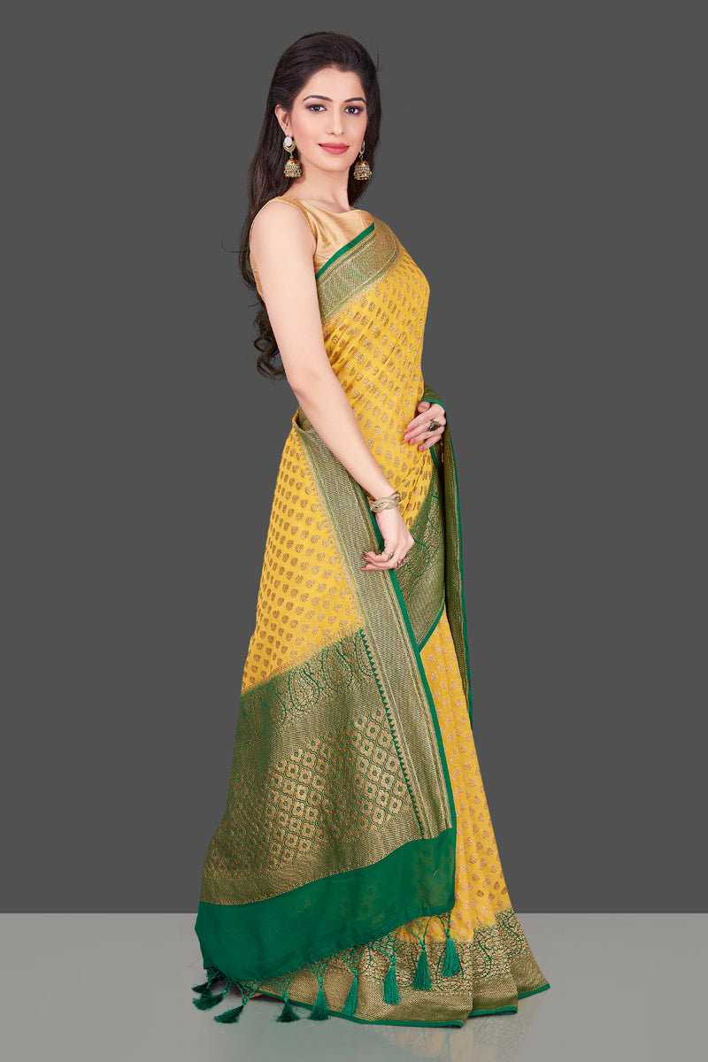 Shop lovely yellow georgette Banarasi saree online in USA with green zari border. Shop beautiful Banarasi georgette sarees, tussar sarees, pure muga silk sarees in USA from Pure Elegance Indian fashion boutique in USA. Get spoiled for choices with a splendid variety of Indian saris to choose from! Shop now.-side