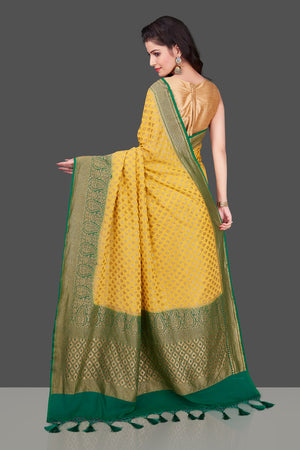 Shop lovely yellow georgette Banarasi saree online in USA with green zari border. Shop beautiful Banarasi georgette sarees, tussar sarees, pure muga silk sarees in USA from Pure Elegance Indian fashion boutique in USA. Get spoiled for choices with a splendid variety of Indian saris to choose from! Shop now.-back