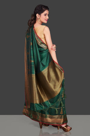 Shop beautiful dark green zari check tassar Banarasi sari in USA with antique zari border. Shop beautiful Banarasi georgette sarees, tussar saris, pure muga silk saris in USA from Pure Elegance Indian fashion boutique in USA. Get spoiled for choices with a splendid variety of Indian sarees to choose from! Shop now.-side
