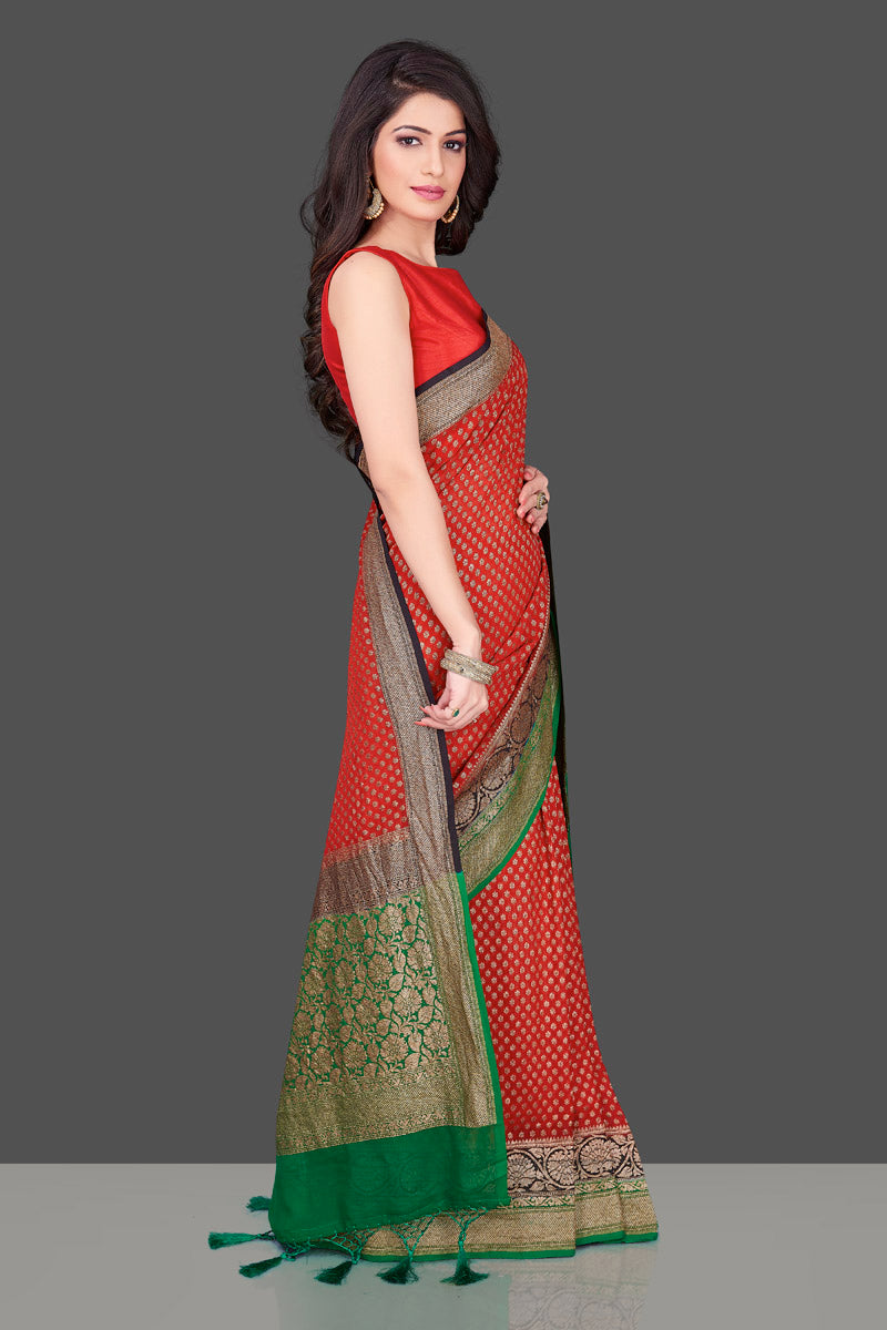 Shop stunning red georgette Benarasi saree in USA with black green zari border. Shop beautiful Banarasi georgette sarees, tussar saris, pure muga silk saris in USA from Pure Elegance Indian fashion boutique in USA. Get spoiled for choices with a splendid variety of Indian sarees to choose from! Shop now.-right side