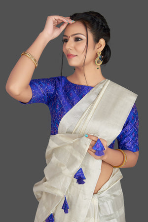 Buy lovely off-white tassar silk sari online in USA with blue patola ikkat saree blouse. Make your ethnic wardrobe rich with timeless handwoven sarees, tissue sarees, silk sarees, tussar saris from Pure Elegance Indian clothing store in USA. Find all the designer sarees for special occasions under one roof!-closeup
