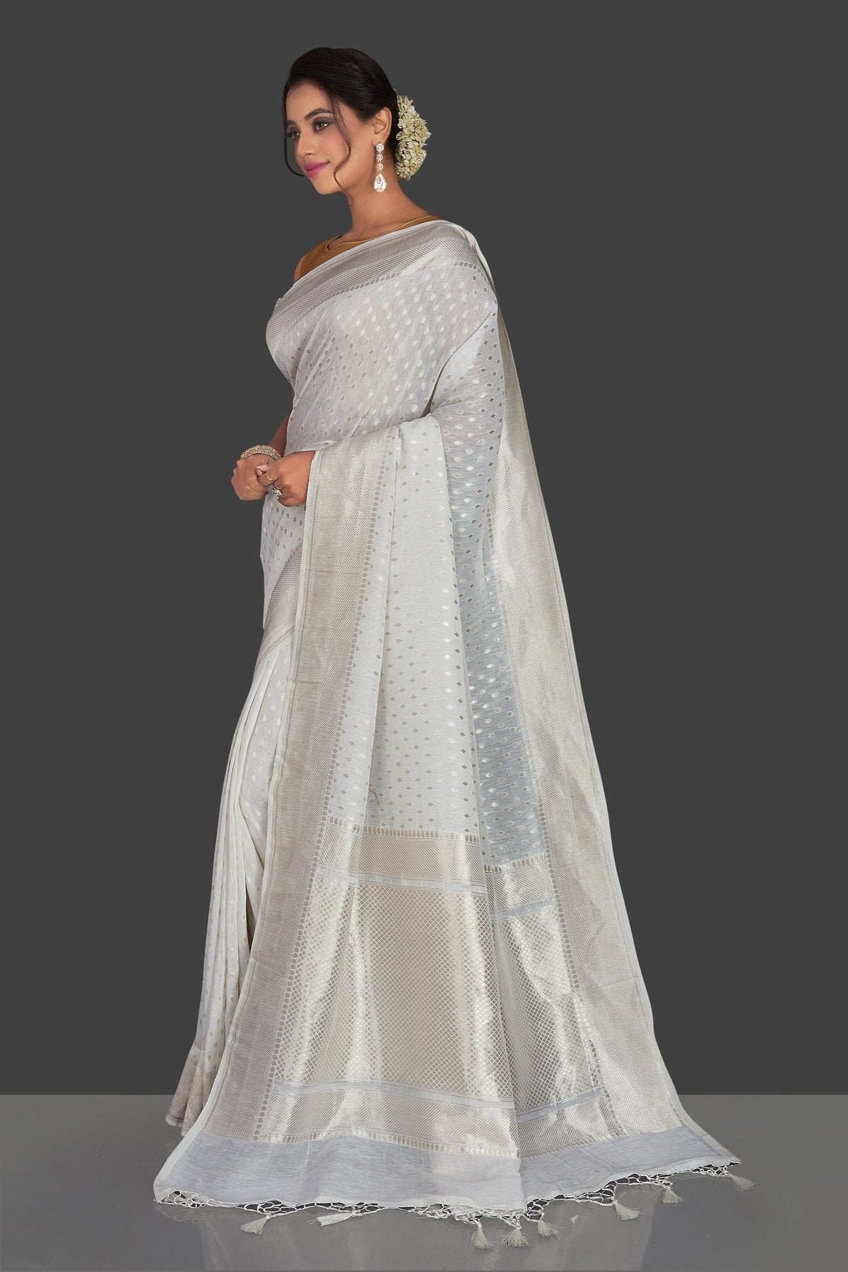 Shop white tassar georgette Banarsi saree online in USA with silver zari border. Radiate elegance with handloom sarees with blouse, tussar silk saris, Banarsi sarees from Pure Elegance Indian fashion boutique in USA. We bring a especially curated collection of ethnic saris for Indian women in USA under one roof!-full view