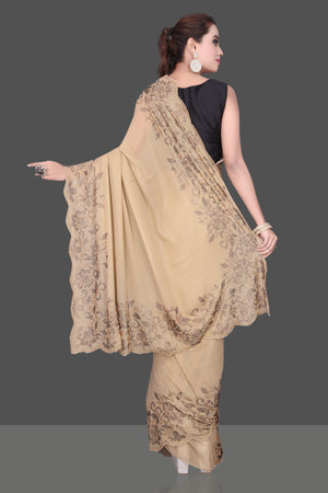 Shop stunning beige color stone work georgette saree online in USA. Be the talk of the parties and special occasions with stunning embroidered sarees, designer sarees, pure silk saris, Bollywood sarees from Pure Elegance Indian fashion store in USA.-back