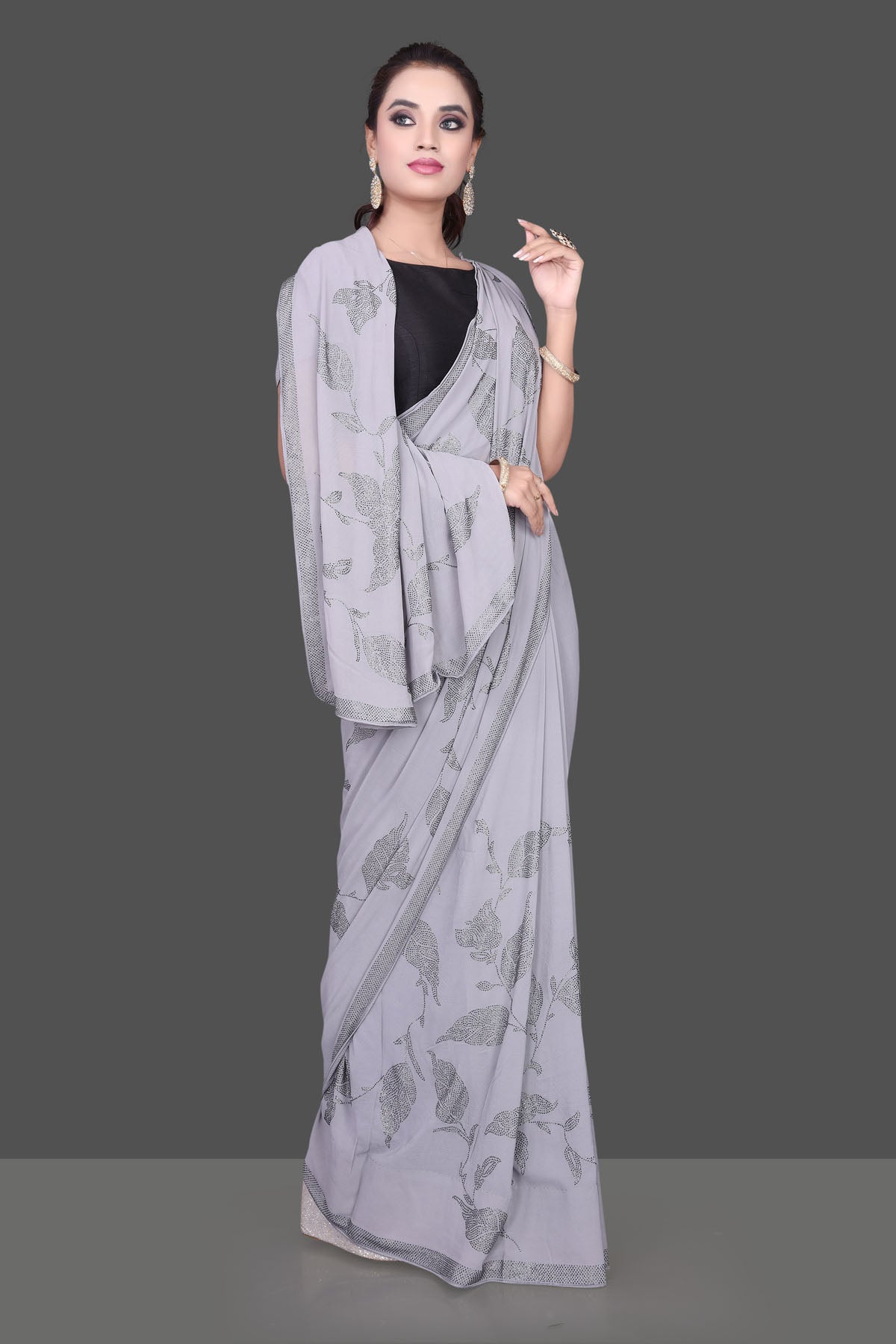 Shop gorgeous grey stone work georgette saree online in USA. Be the talk of the parties and special occasions with stunning embroidered sarees, designer sarees, pure silk saris, Bollywood sarees from Pure Elegance Indian fashion store in USA.-front