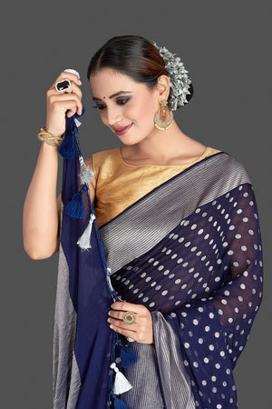 Buy beautiful dark blue georgette Banarasi saree online in USA with silver zari border and buta. Elevate your traditional style with beautiful Banarasi sarees, designer sarees, pure silk sarees, handwoven saris from Pure Elegance Indian saree store in USA.-closeup