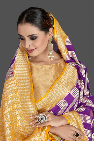 Buy beautiful purple georgette Banarasi saree online in USA with yellow zari border. Elevate your traditional style with beautiful Banarasi sarees, designer sarees, pure silk sarees, handwoven saris from Pure Elegance Indian saree store in USA.-closeup