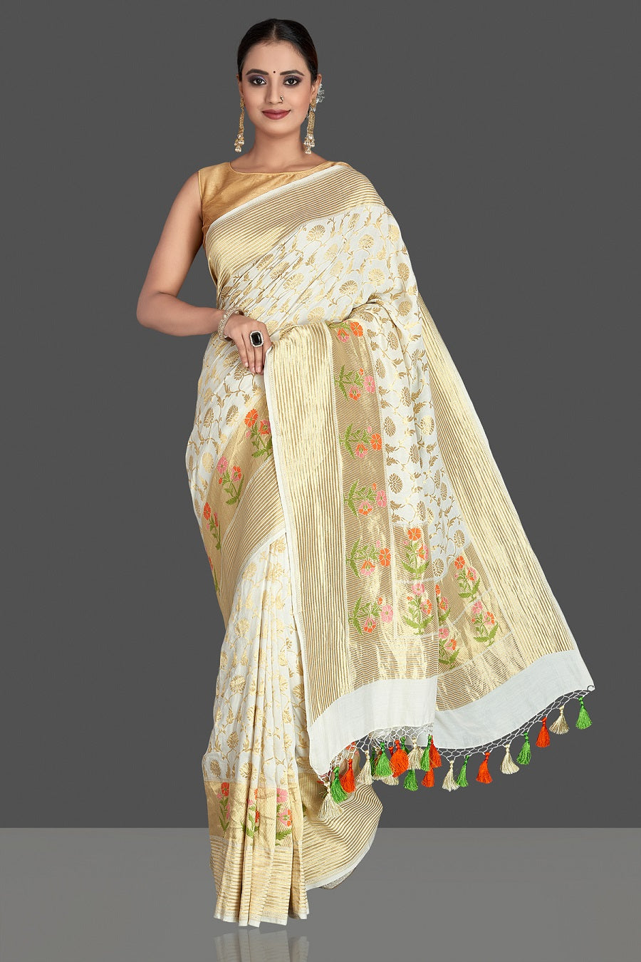 Buy beautiful off-white georgette Banarasi saree online in USA with zari minakari buta on golden zari border. Elevate your traditional style with beautiful Banarasi sarees, designer sarees, pure silk sarees, handwoven saris from Pure Elegance Indian saree store in USA.-front