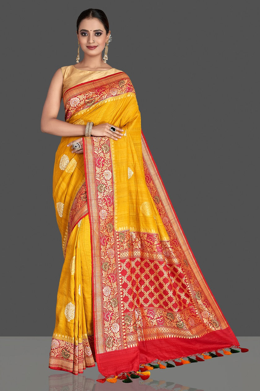 Buy stunning yellow tussar georgette Banarasi saree online in USA with red zari minakari border. Elevate your traditional style with beautiful Banarasi sarees, designer sarees, pure silk sarees, handwoven saris from Pure Elegance Indian saree store in USA.-full view