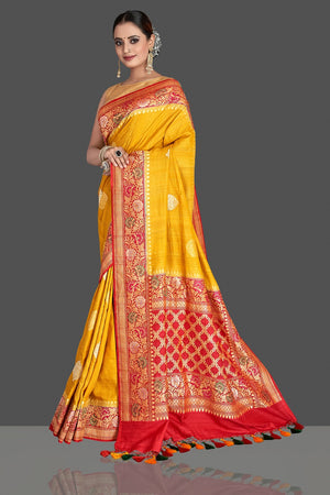 Buy stunning yellow tussar georgette Banarasi saree online in USA with red zari minakari border. Elevate your traditional style with beautiful Banarasi sarees, designer sarees, pure silk sarees, handwoven saris from Pure Elegance Indian saree store in USA.-pallu