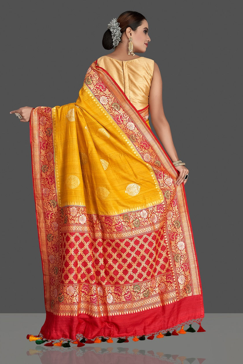 Buy stunning yellow tussar georgette Banarasi saree online in USA with red zari minakari border. Elevate your traditional style with beautiful Banarasi sarees, designer sarees, pure silk sarees, handwoven saris from Pure Elegance Indian saree store in USA.-back