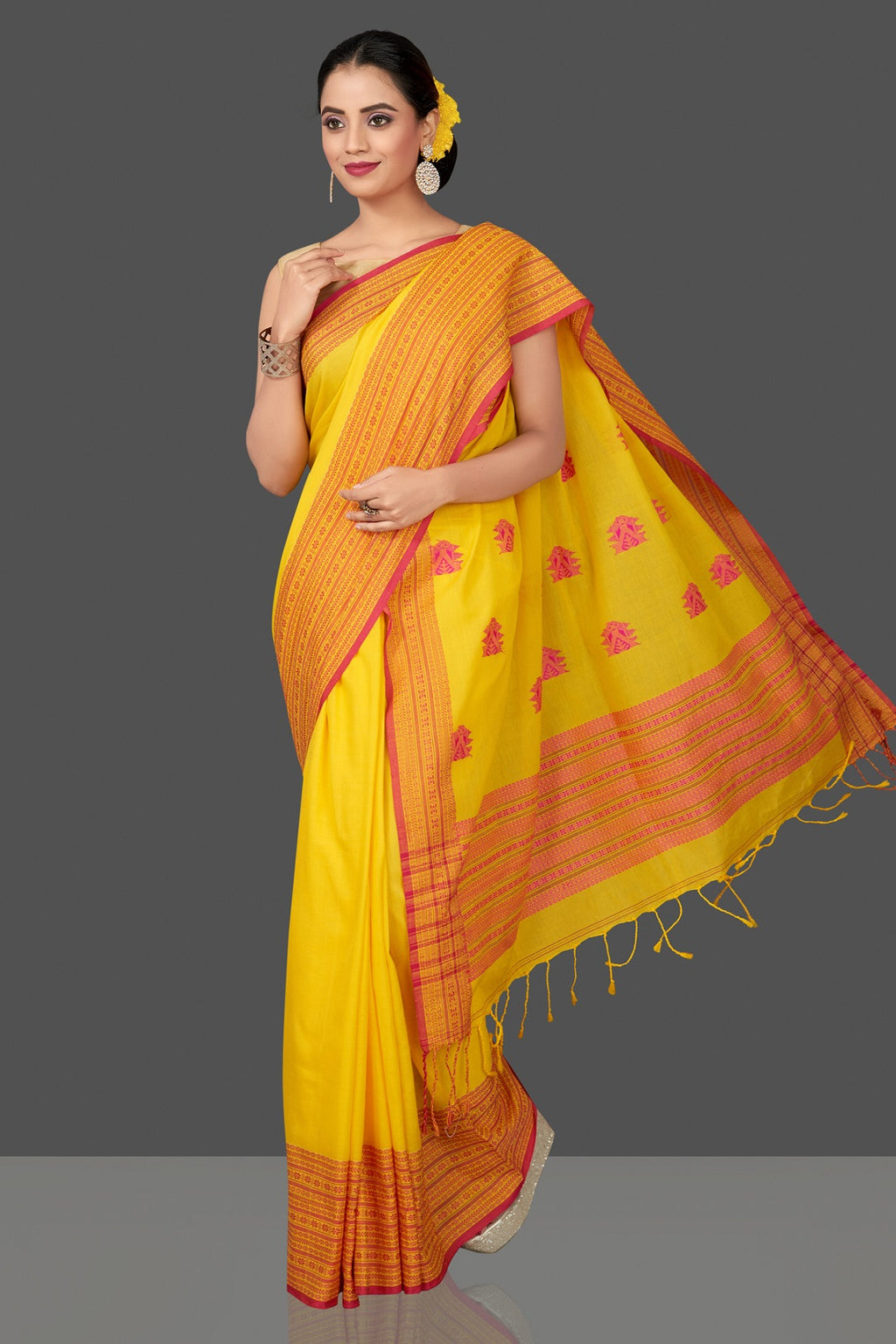 Buy bright yellow color cotton saree online in USA with broad Assam design pallu. Flaunt Indian fashion in USA with a stunning collection of handwoven sarees, cotton sarees, pure silk sarees, designer saris in USA from Pure Elegance Indian saree store in USA.-full view