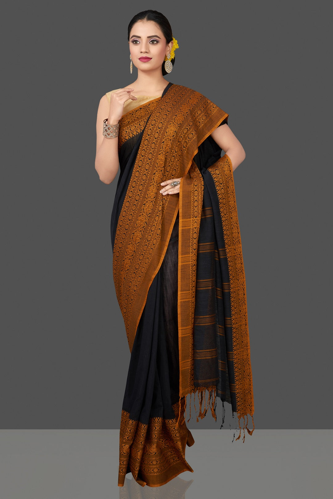 Shop gorgeous black Dongria cotton saree online in USA with mustard weave border. Flaunt Indian fashion in USA with a stunning collection of handwoven sarees, cotton saris, pure silk sarees, printed saris in USA from Pure Elegance Indian saree store in USA.-front