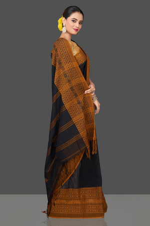 Shop gorgeous black Dongria cotton saree online in USA with mustard weave border. Flaunt Indian fashion in USA with a stunning collection of handwoven sarees, cotton saris, pure silk sarees, printed saris in USA from Pure Elegance Indian saree store in USA.-side