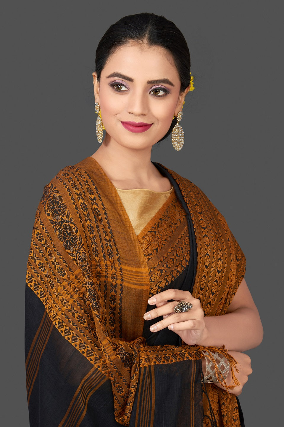 Shop gorgeous black Dongria cotton saree online in USA with mustard weave border. Flaunt Indian fashion in USA with a stunning collection of handwoven sarees, cotton saris, pure silk sarees, printed saris in USA from Pure Elegance Indian saree store in USA.-closeup