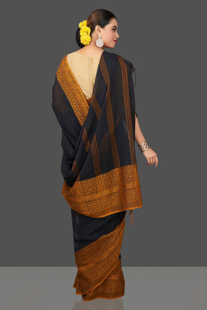 Shop gorgeous black Dongria cotton saree online in USA with mustard weave border. Flaunt Indian fashion in USA with a stunning collection of handwoven sarees, cotton saris, pure silk sarees, printed saris in USA from Pure Elegance Indian saree store in USA.-back