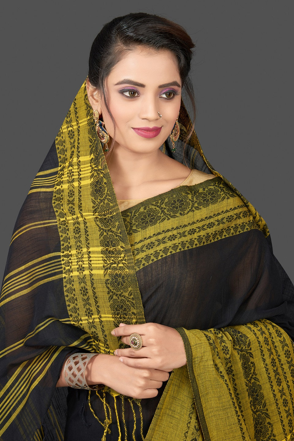 Buy gorgeous black Dongria cotton saree online in USA with yellow weave border. Flaunt Indian fashion in USA with a stunning collection of handwoven sarees, cotton saris, pure silk sarees, printed saris in USA from Pure Elegance Indian saree store in USA.-closeup