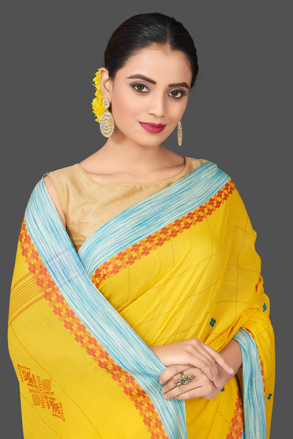Shop stunning yellow cotton saree online in USA with blue border. Flaunt Indian fashion in USA with a stunning collection of handwoven sarees, cotton saris, pure silk sarees, printed saris in USA from Pure Elegance Indian saree store in USA.-closeup