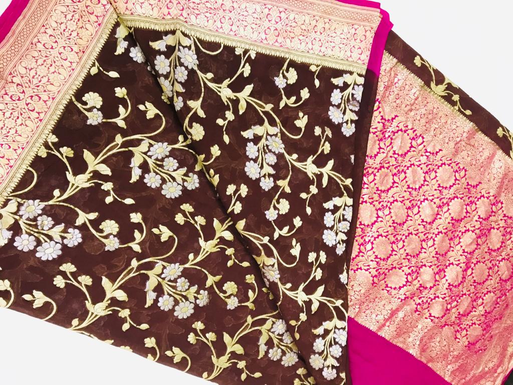 Buy gorgeous brown georgette Banarasi saree online in USA with pink zari border. Make a fashion statement at weddings with stunning designer sarees, embroidered sarees with blouse, wedding sarees, handloom sarees from Pure Elegance Indian fashion store in USA.-front