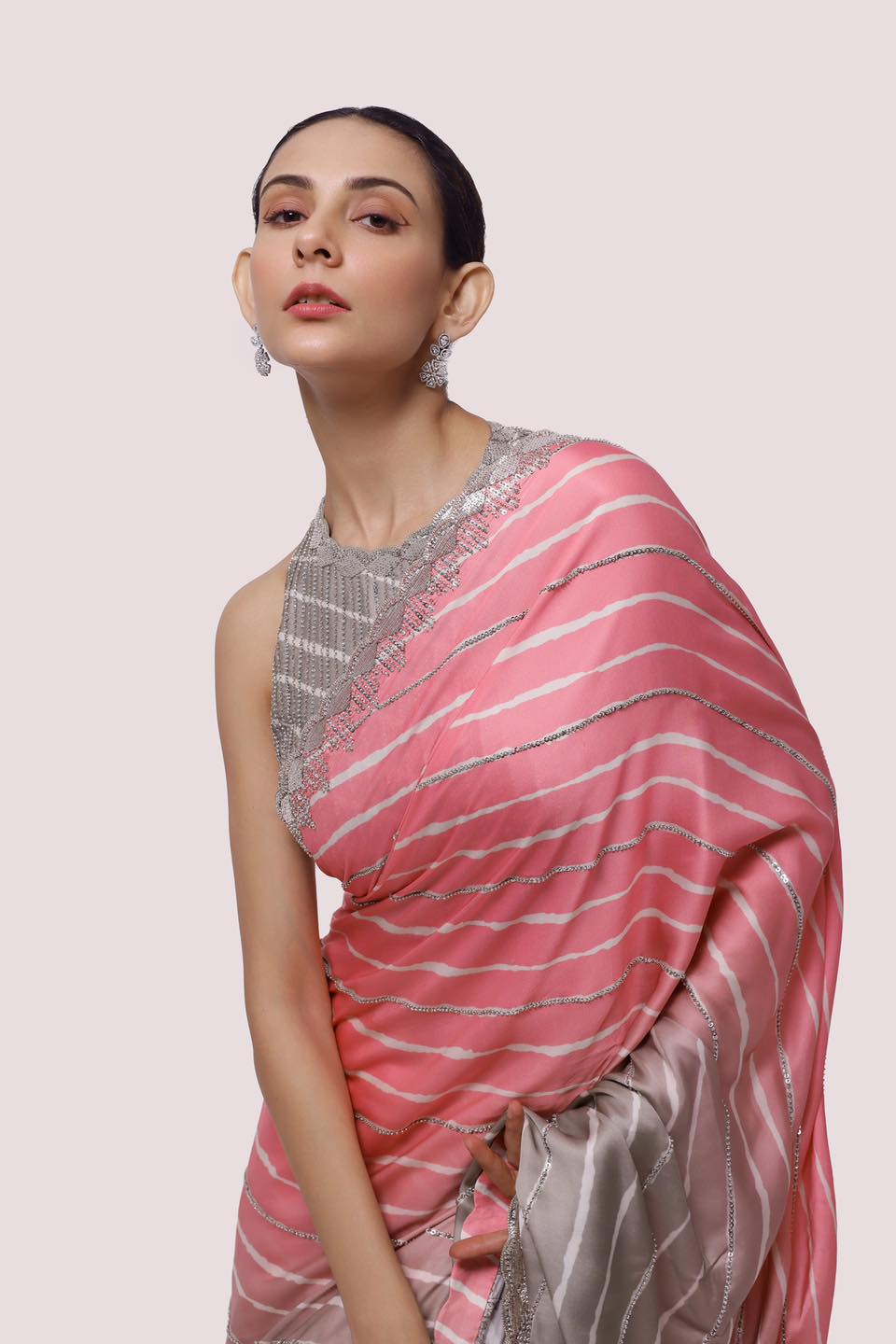 Shop ash grey and pink embellished satin saree online in USA with blouse. Make a fashion statement on festive occasions and weddings with designer sarees, designer suits, Indian dresses, Anarkali suits, palazzo suits, designer gowns, sharara suits, embroidered sarees from Pure Elegance Indian fashion store in USA.-closeup