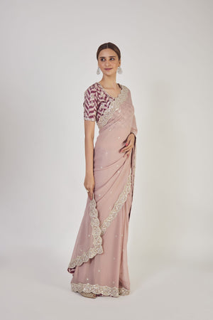 Buy beautiful dusty pink embroidered georgette saree online in USA with blouse. Make a fashion statement on festive occasions and weddings with designer sarees, designer suits, Indian dresses, Anarkali suits, palazzo suits, designer gowns, sharara suits, embroidered sarees from Pure Elegance Indian fashion store in USA.-side