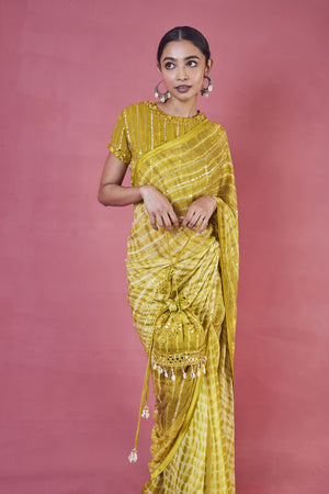 Buy beautiful mustard printed cutdana work georgette saree online in USA with blouse. Make a fashion statement on festive occasions and weddings with designer sarees, designer suits, Indian dresses, Anarkali suits, palazzo suits, designer gowns, sharara suits, embroidered sarees from Pure Elegance Indian fashion store in USA.-closeup