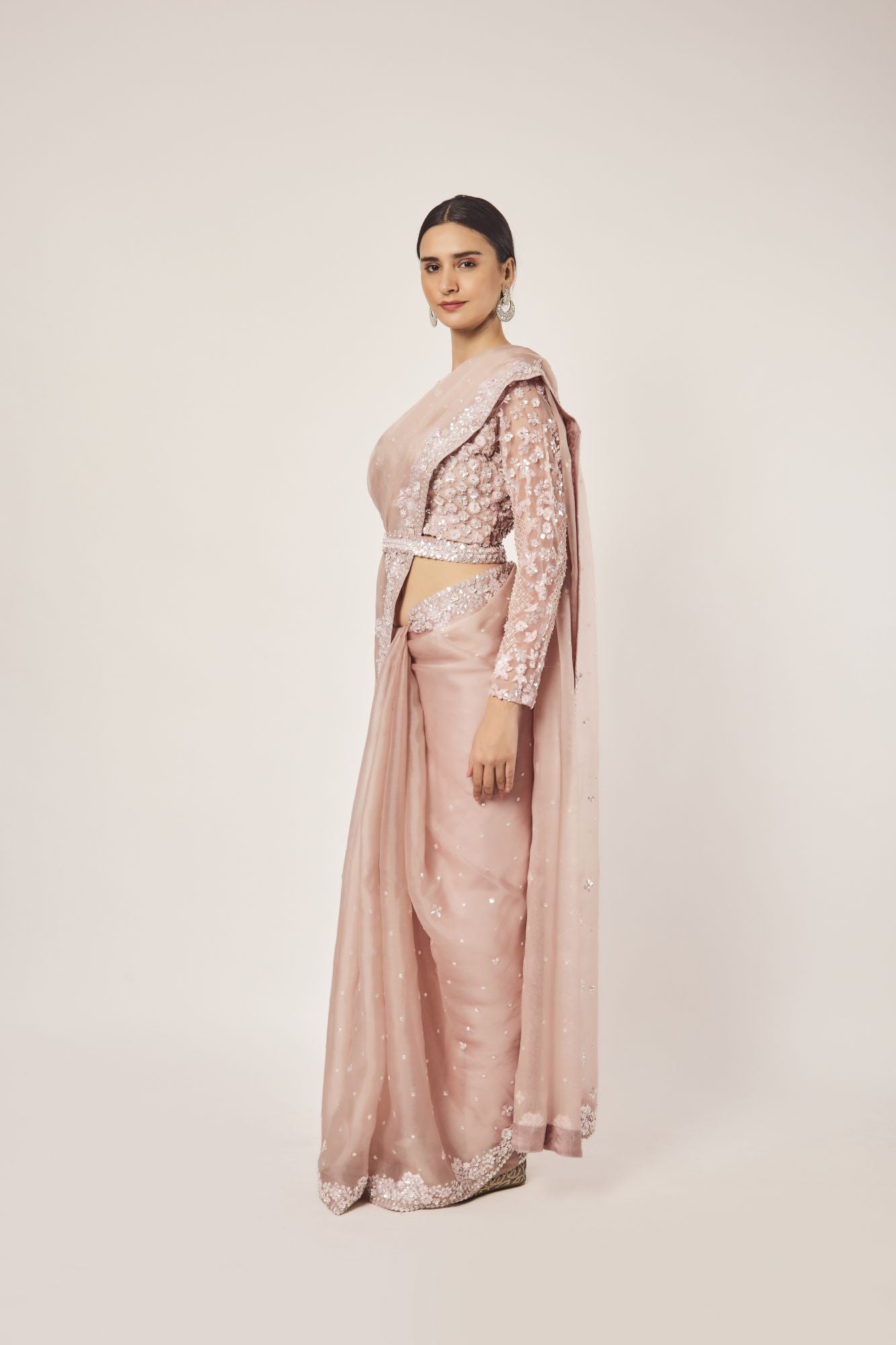 Shop dusty pink embroidered organza saree online in USA with blouse. Make a fashion statement on festive occasions and weddings with designer sarees, designer suits, Indian dresses, Anarkali suits, palazzo suits, designer gowns, sharara suits, embroidered sarees from Pure Elegance Indian fashion store in USA.-left